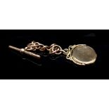 A 9ct rose gold watch fob, with an 9ct yellow gold hinged locket set in a spin seal mount