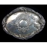 A silver dressing table tray, quatrefoil shape embossed with foliate vacant reserve and poppy