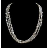 A three strand fresh water pearl necklace, with circular half pearl clasp of 1.3cm diam,. set in