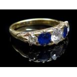 A five stone diamond and sapphire ring, the central diamond 0.40ct approx