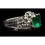 An emerald and diamond ring, the 2.00ct stone set in three rows of scattered brilliant and bagette