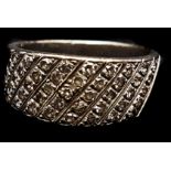 A pave set diamond ring, the stones set on the oblique in white gold, stamped 14ct, ring size M,