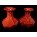 A pair of Lithyalin red glass vases, probably by Friedrich Egermann, of facetted bottle form, bright