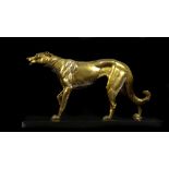 An Art Deco bronze metal figure of a borzoi, standing with front paw raised, on rectangular black