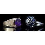 A sapphire and diamond dome ring, the central diamond set with two concentric rings of sapphires, in