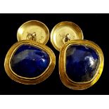 A pair of lapis and yellow gold cufflinks, the cabouchon natural shape stones set in irregular