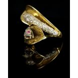 A diamond and ruby double serpent head dress ring, crossover form, each snake head set with nine