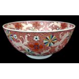 A Chinese enamelled punch bowl, decorated with foliate scrolls on a rose pink ground, 30.5cm diam