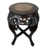 A Chinese hardwood carved stand, the circular top inset with variegated red/ochre marble, the