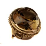 A smokey topaz and 9ct gold brooch/pendant, oval set in rope and barley twist oval mount
