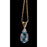 An aquamarine and diamond pendant, the oval aquamarine set with single diamond, in 9ct yellow gold