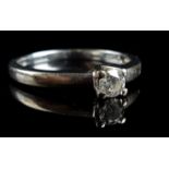 An 18ct white gold solitaire diamond ring, 0.15ct stone approx, ring size M 1/2