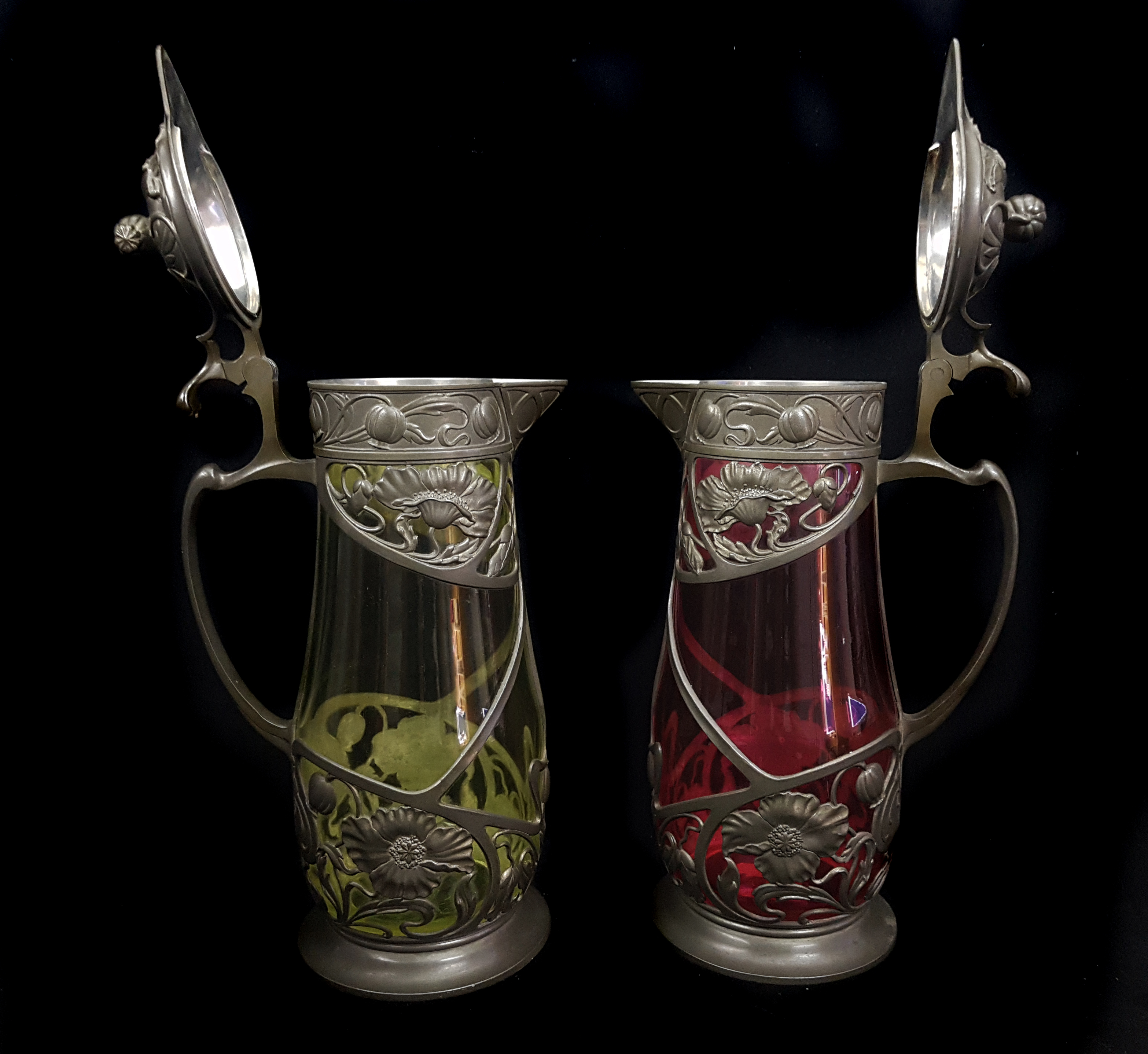 A pair of Continental pewter mounted glass claret jugs, the metal formed as Art Nouveau floral - Image 2 of 4