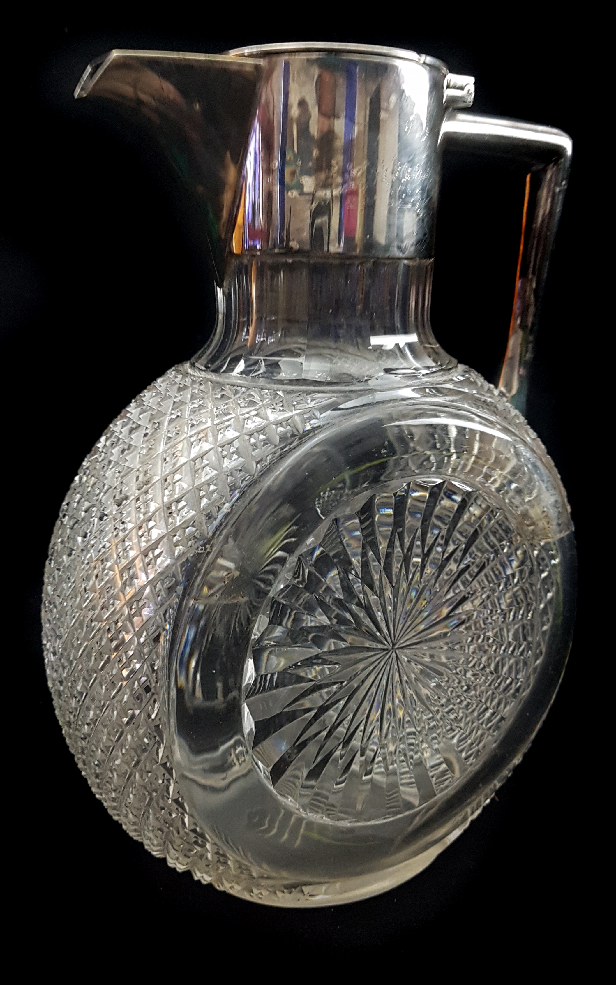 A cut glass silver plated mounted claret jug, circular body with star cut roundel 19cm high