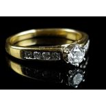 An 18ct yellow gold and diamond ring, the central stone approx 0.25ct, flanked by four smaller