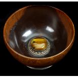 A turned wood Mazer bowl, the interior set with a large cabouchon Tigers Eye stone with metal mount