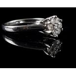 An 18ct white gold and diamond ring, of seven stones arranged in flower form, 0.25ct approx total,