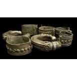 A pair of white metal anklets, probably Omani; and five similar bracelets (7)