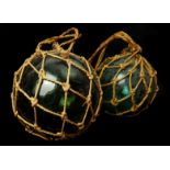 Three Cornish fisherman's floats green glass globes, two with string bags (3)