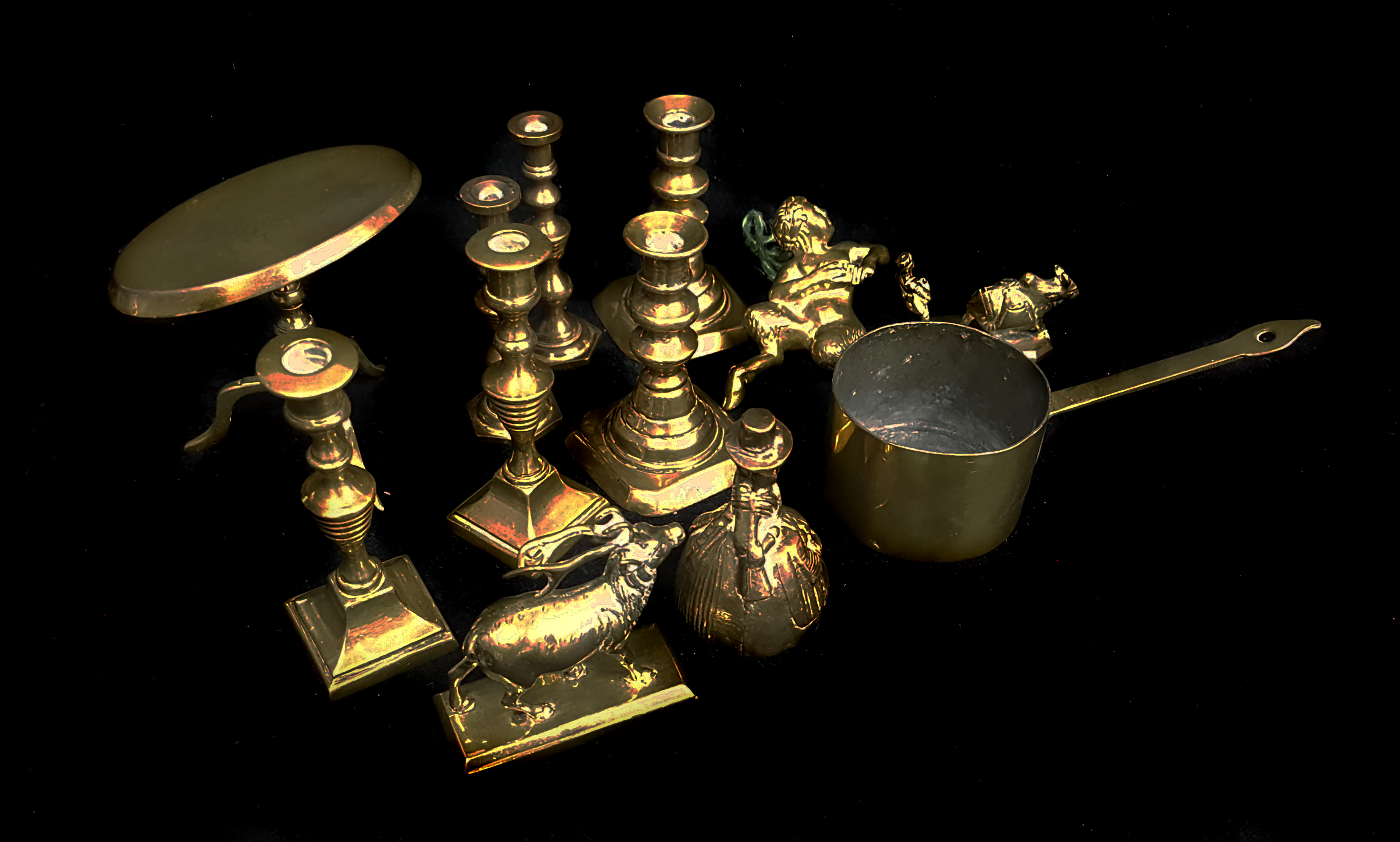 A collection of miniature brass items including a tilt top table; three pairs of candlesticks and