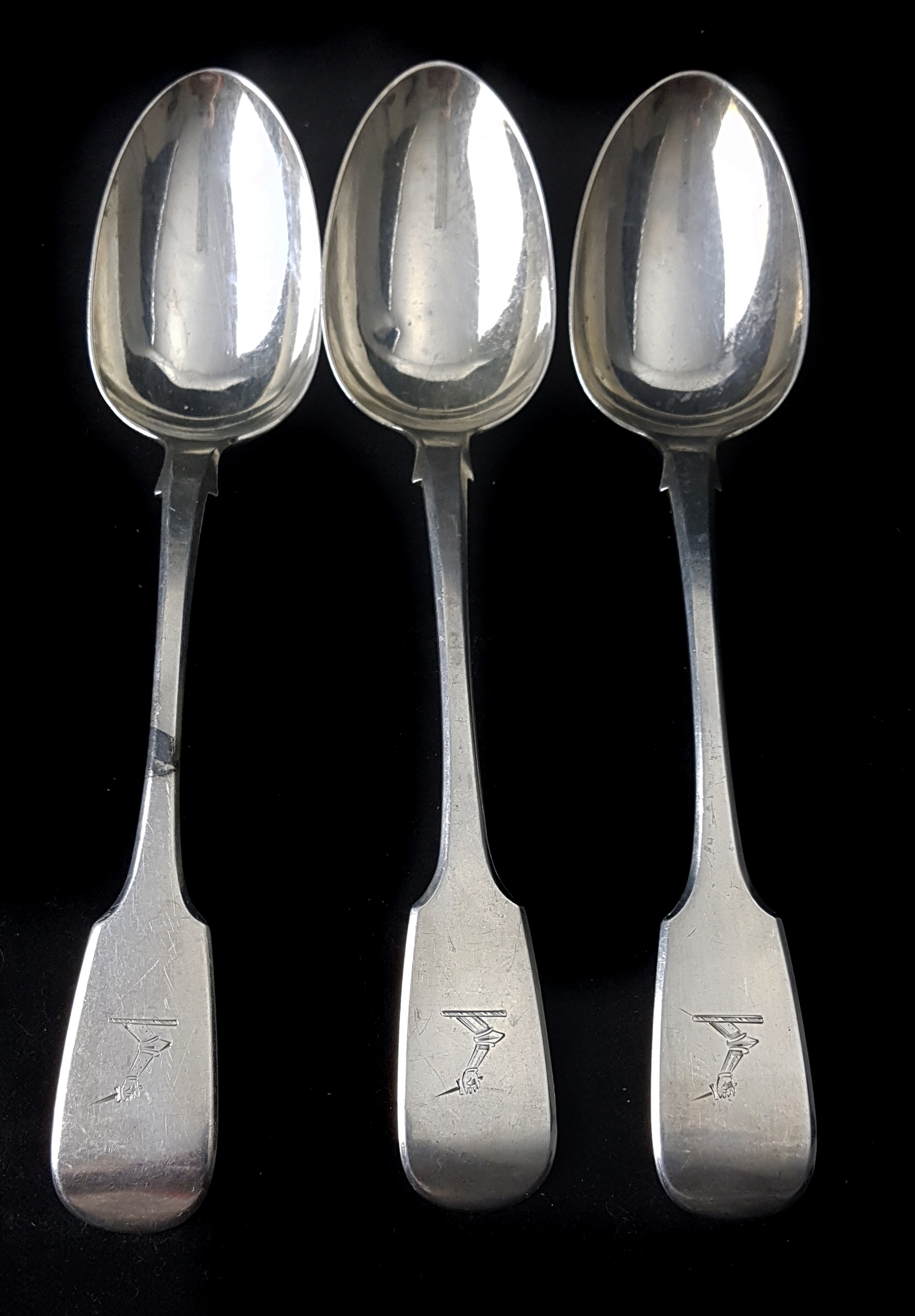 Three crested Irish silver table spoons, Dublin 1870, makers mark, JS in oval for John Smith,