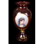 A Bohemain ruby glass vase with portrait medallion of a young girl, the ruby glass gilded overall