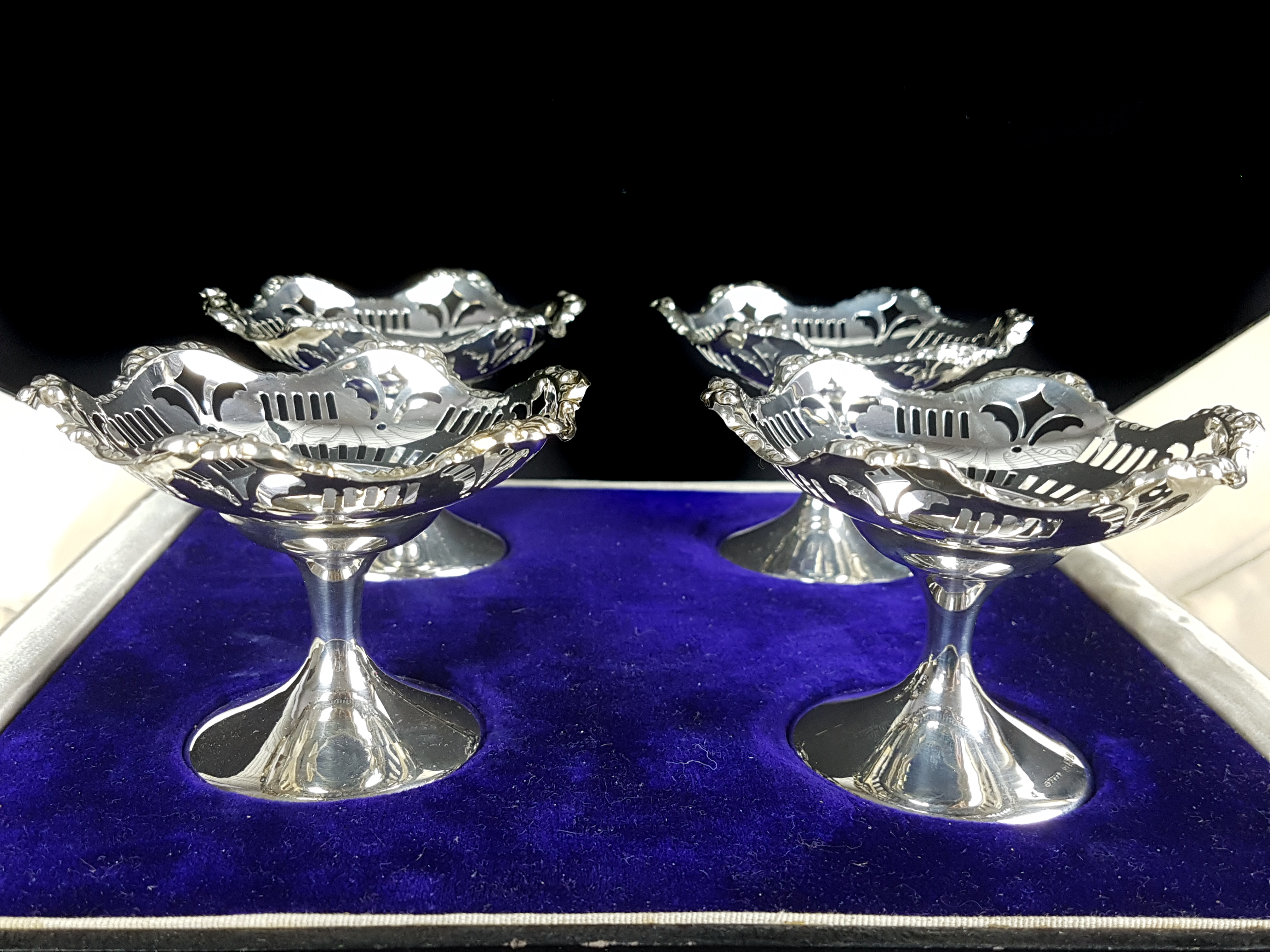 A cased set of four silver sweetmeat dishes, circular footed form, Birmingham 1924, makers mark SB&S