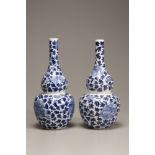 A pair of blue and white double gourd vases