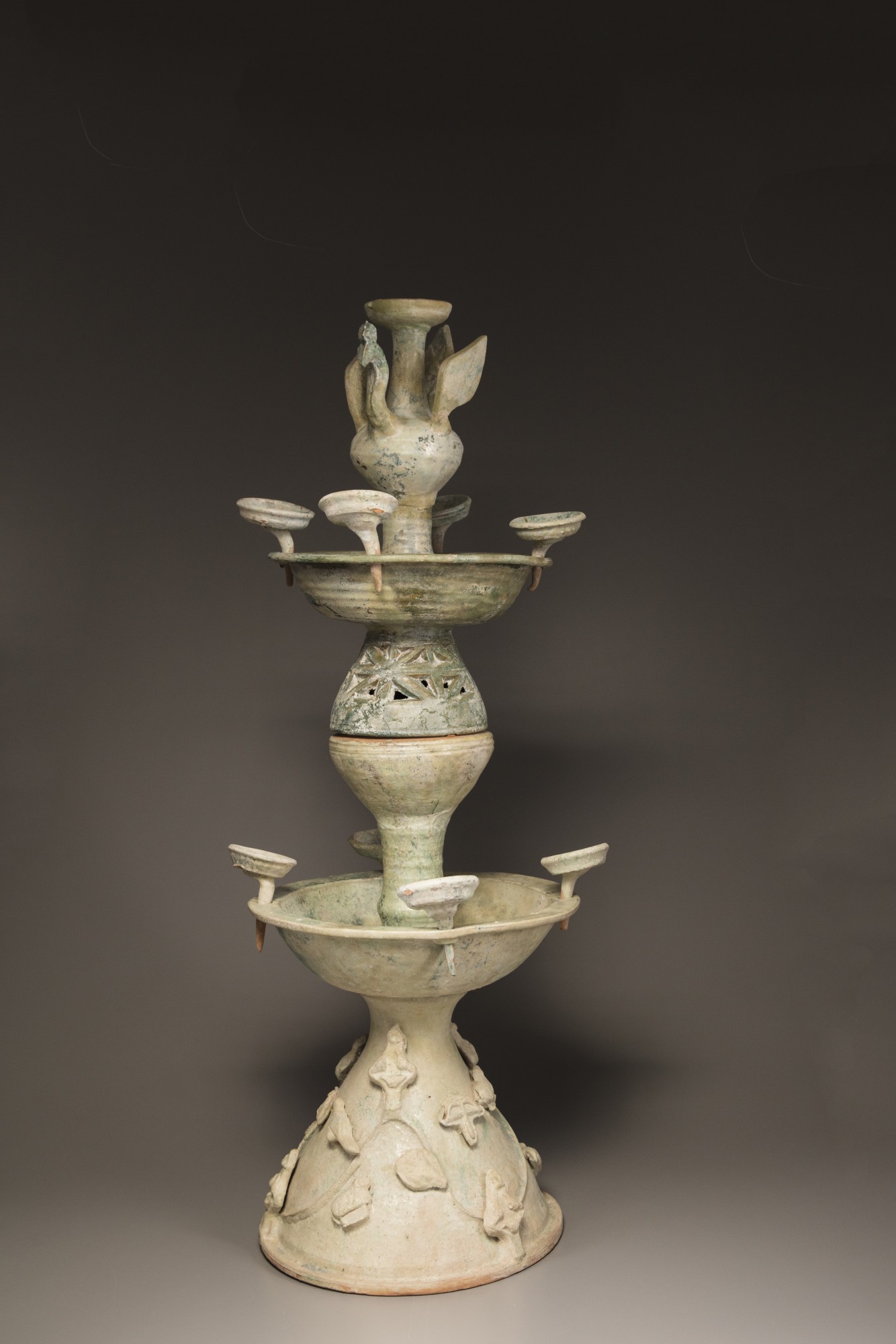 A green-glazed pottery two-tiered oil lamp