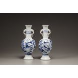 A similar pair of blue and white moulded vases