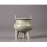 A celadon-glazed tripod censer