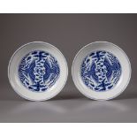 A pair of Chinese blue and white 'phoenix' dishes