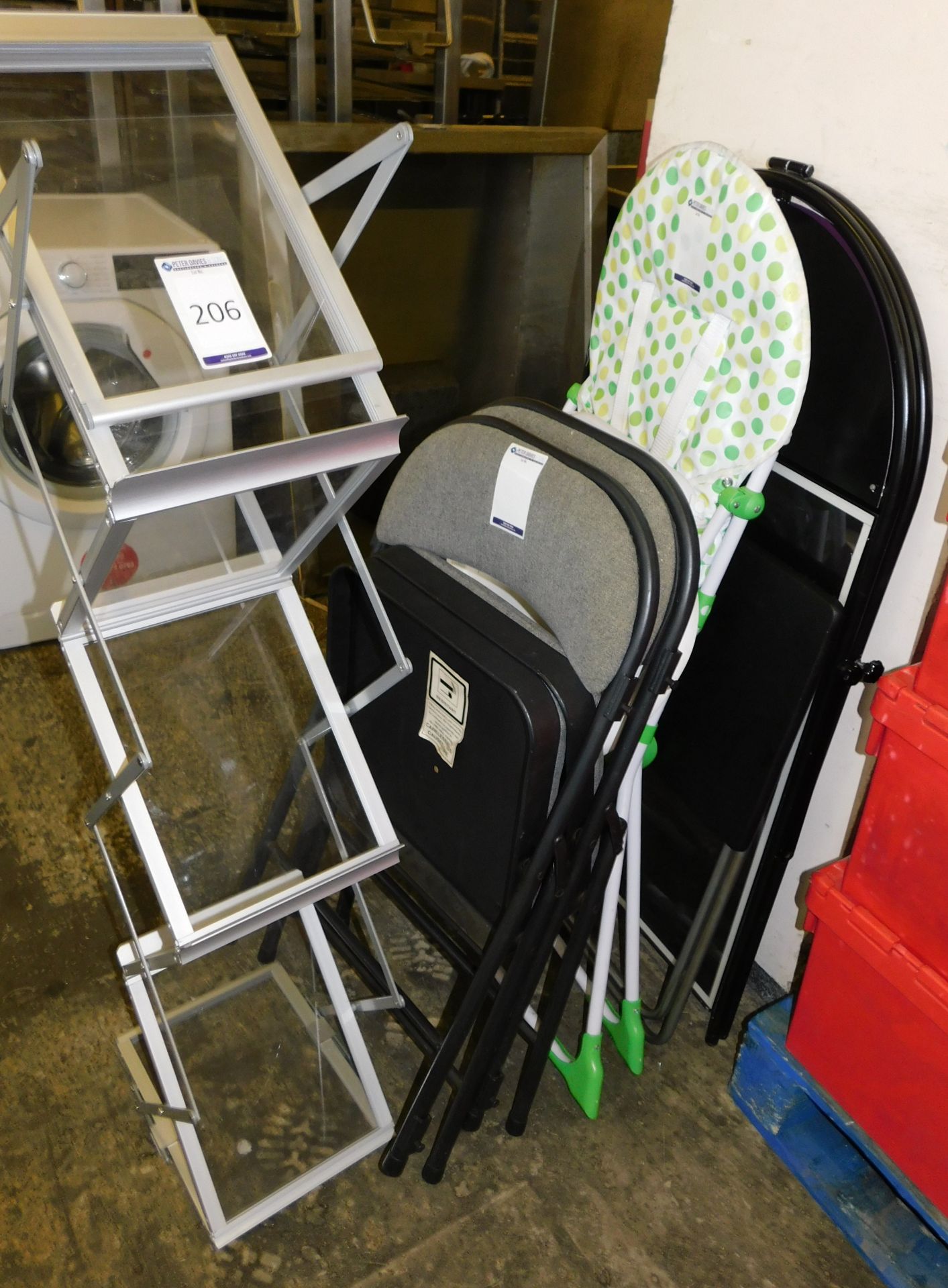 Magazine Stand, Folding Table, 2 Folding Chairs, Childs High Chair & A-Board (Located The Auction