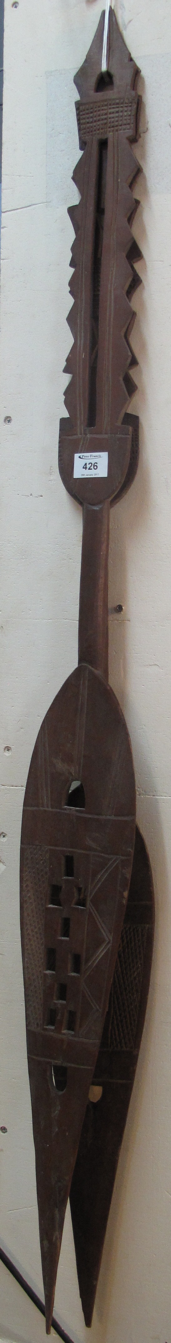 Two similar hardwood tribal paddles.