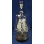 Spun glass ship in conical shaped decanter with extended neck, the ship with frosted glass sails,