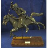 Bronzed spelter figure of a mounted warrior at full gallop, on wooden base.