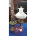 Brass double burner oil lamp with brass reservoir and base, opaque shade and clear chimney,