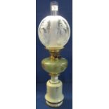 Early 20th Century brass double burner oil lamp with florally painted glass reservoir on a ceramic