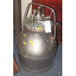 Aluminium milk churn with cover and pipe connections.