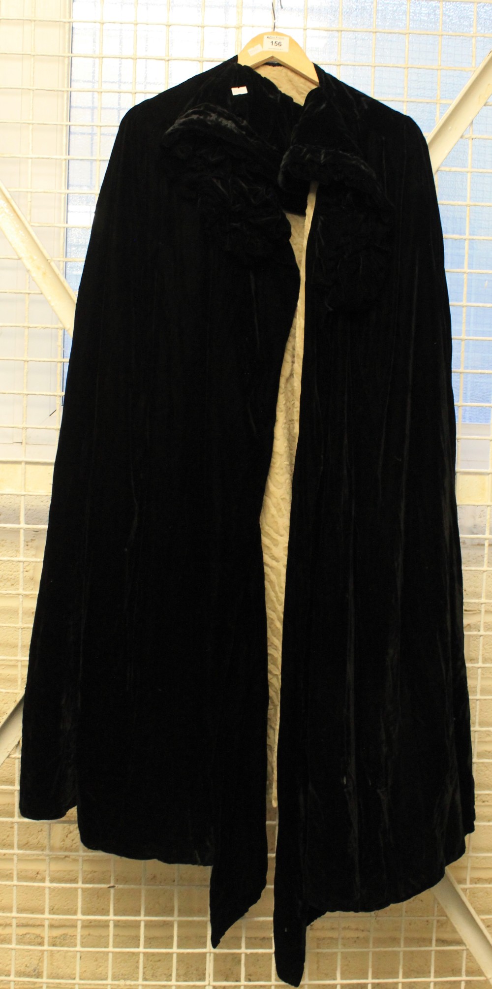 Long black velvet opera cape with crushed velvet lining.