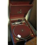 HMV wind-up table top gramophone with red leatherette finish.