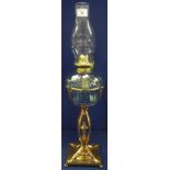 Early 20th Century brass single burner oil lamp with fluted glass reservoir on a decorative brass,