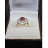 GOLD, DIAMOND AND RUBY DRESS RING, the central ruby, 8mm x 6mm approx.