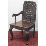 CHINESE CARVED PADOUK WOOD ELBOW CHAIR, having overall relief carved and pierced studies of dragons,