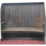 19TH CENTURY CURVED, BARREL BACKED SETTLE of mixed woods with flat canopy,