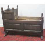 18TH CENTURY PANELLED OAK CRIB, having turned finials, raised and fielded panel sides,