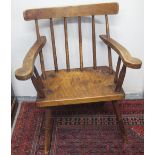 19TH CENTURY IRISH PRIMITIVE ELBOW CHAIR in mixed woods, having over-hanging top rail, spindle back,