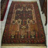 Old style Persian brown ground geometric and foliate rug. 92 x 152cm.