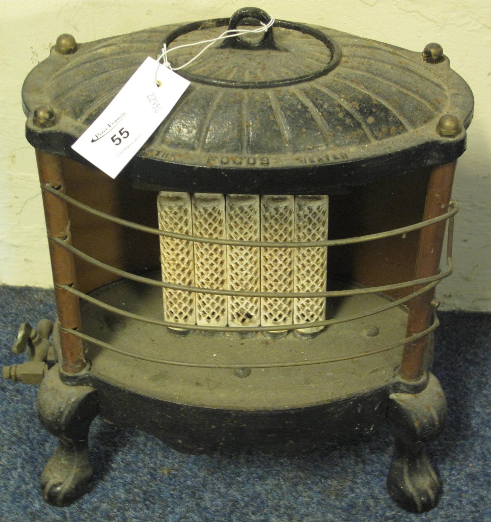 Vintage cast metal gas fire with oval shell shaped top on cabriole type legs. 'The Focus Heater'.