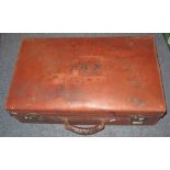 Vintage tan leather suitcase.